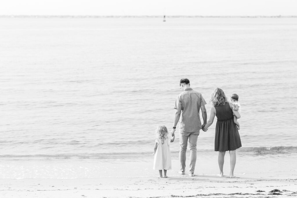 black and white beach photography, family on the beach in the water, mini session tips for photographers