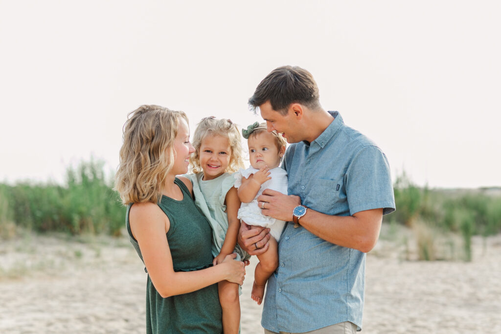 close and cozy standing family photo on the beach